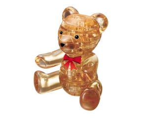 Seated brown bear figure with red bow.